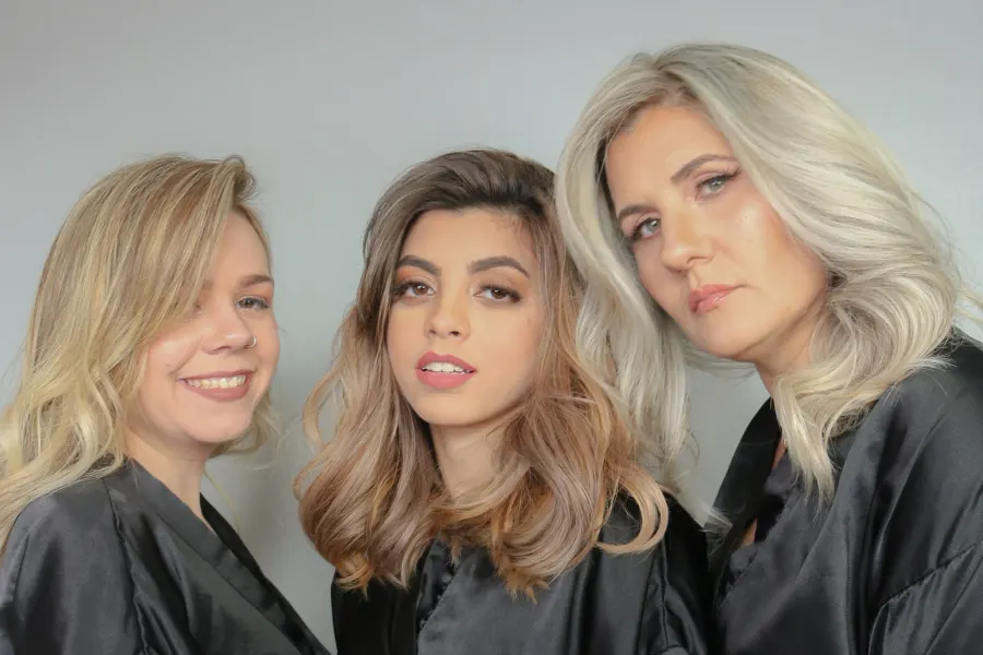 Three clients from the same color session, blonde, bronde and icy, set in soft waves