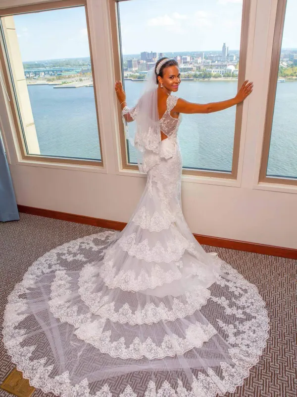 The bride from behind, hair pinned high to sit clear of the neckline