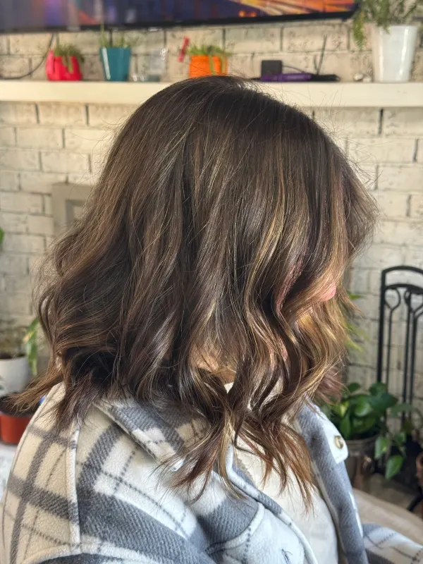 Chocolate brown with fine highlights, finished in loose waves