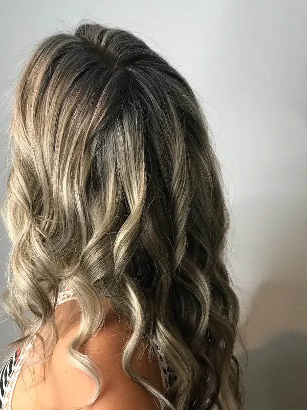 Deep shadow root running into cool blonde ends, the widest contrast the hair can take