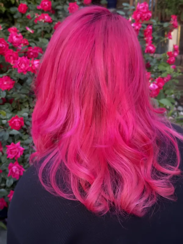 Magenta pink over a dark root, worn long and loose