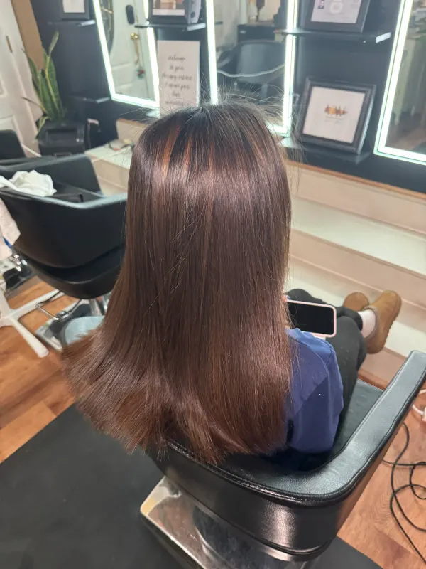 After the smoothing: the same hair straight and glossy from root to end