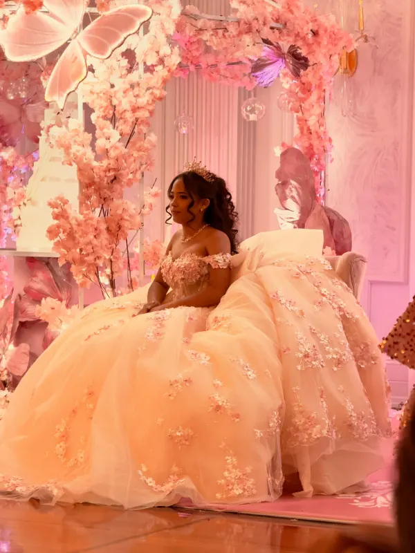Hair taken back off the shoulders to sit clear of an off the shoulder gown